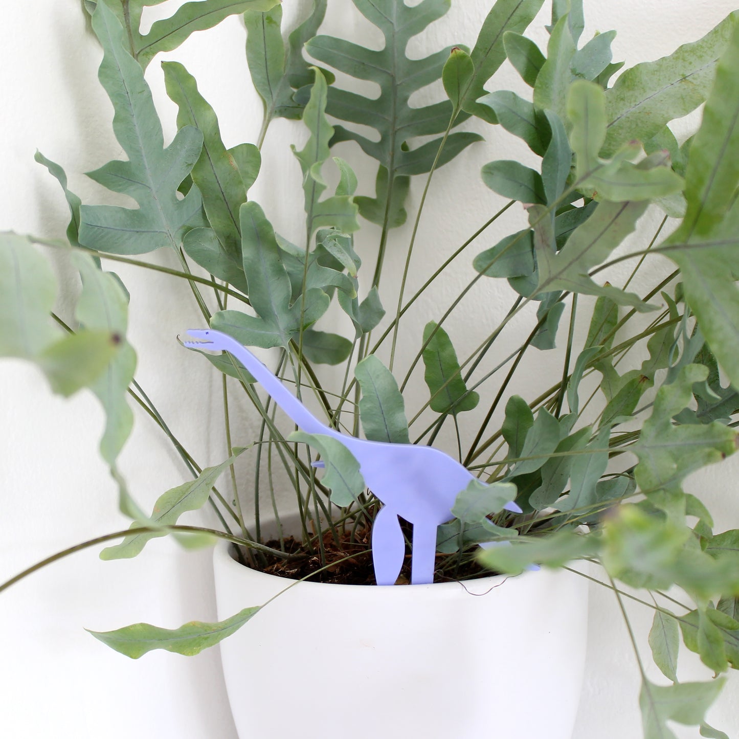 pastel blue plesiosaur dinosaur plant decoration in plant pot