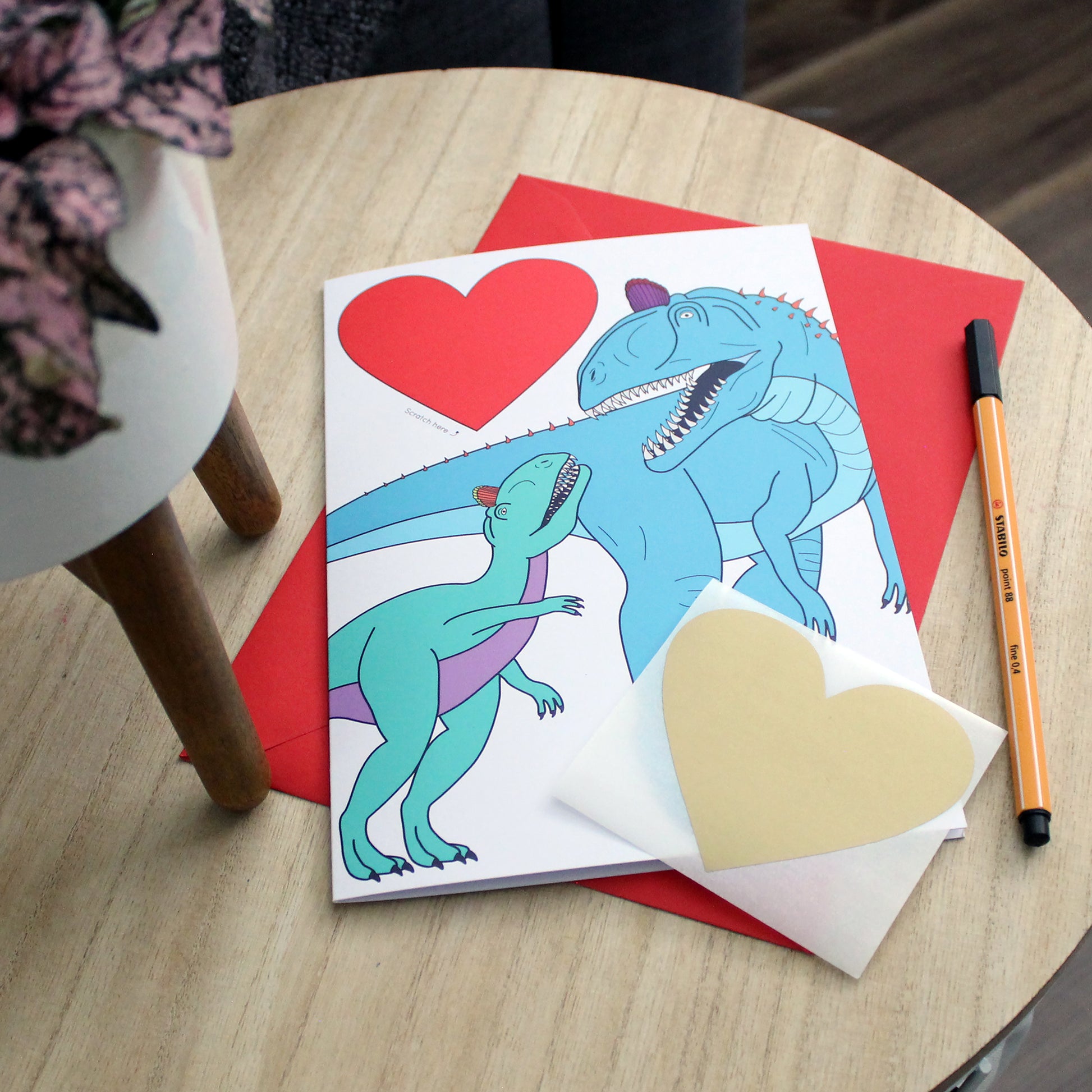 dinosaur heart scratch card on table
