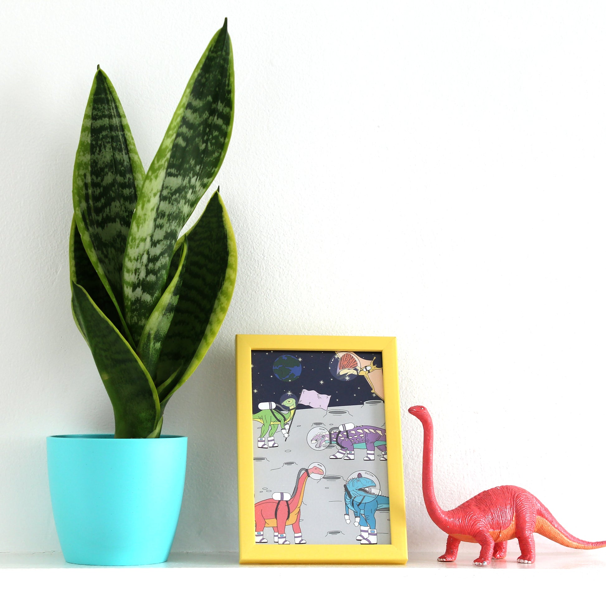 space dinosaur postcard on a shelf