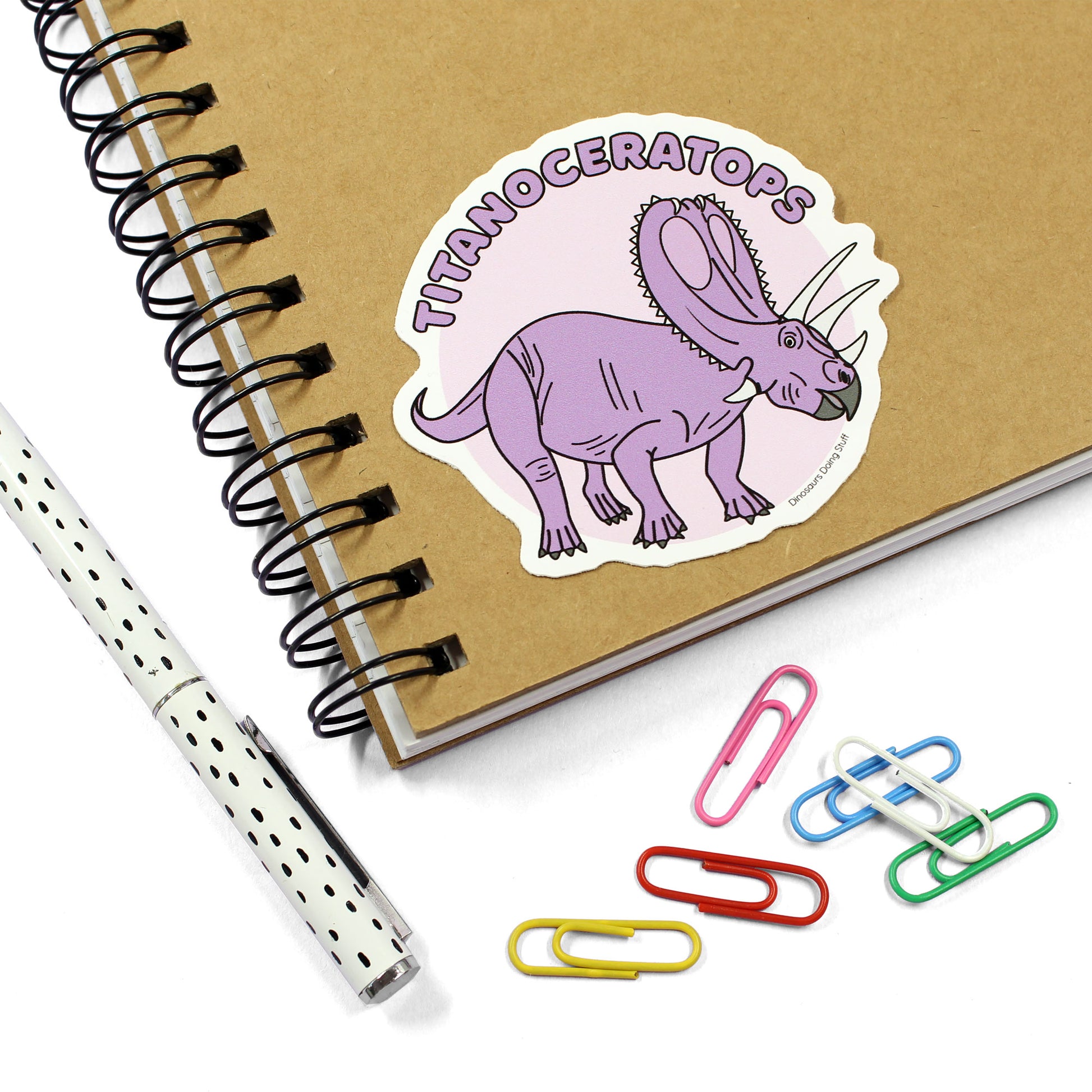 Titanoceratops dinosaur sticker on a notebook