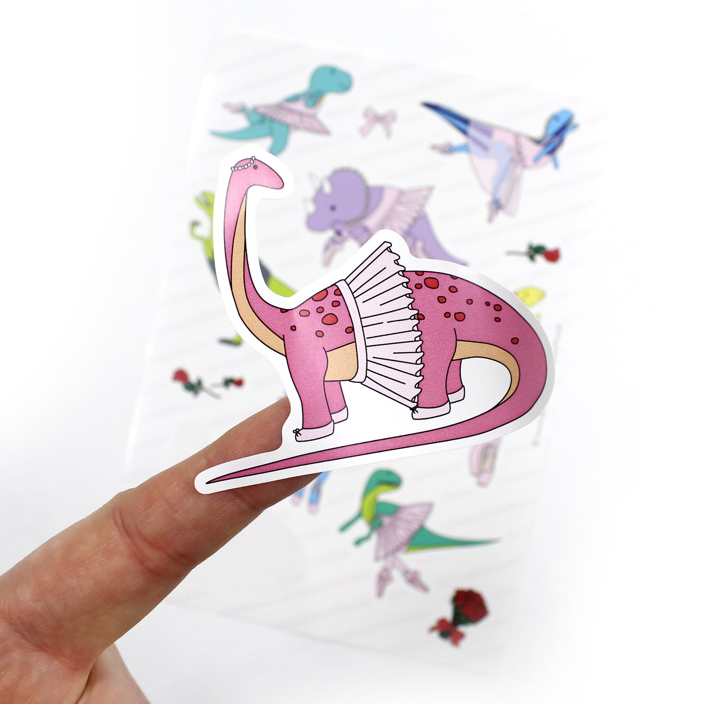 close up of ballet dinosaur sticker with sticker sheet in the background