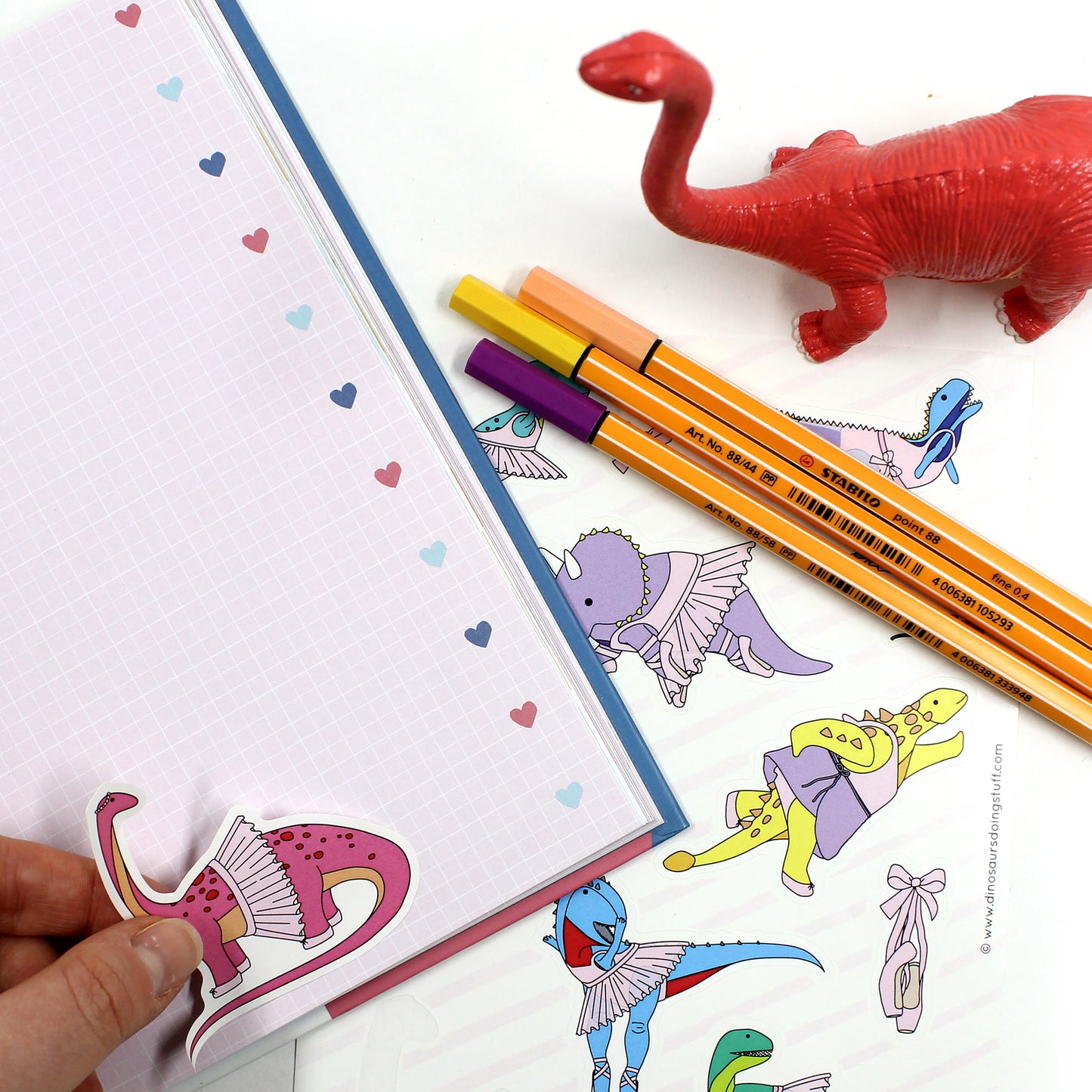 ballet dinosaur stickers on a notebook with pens