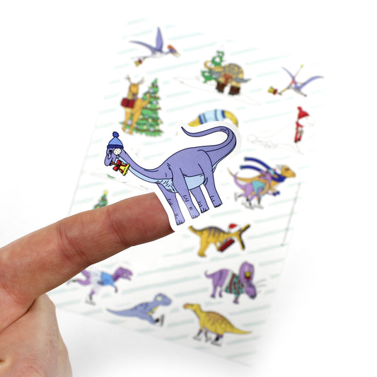 close up of dinosaur Christmas sticker with sheet in the background