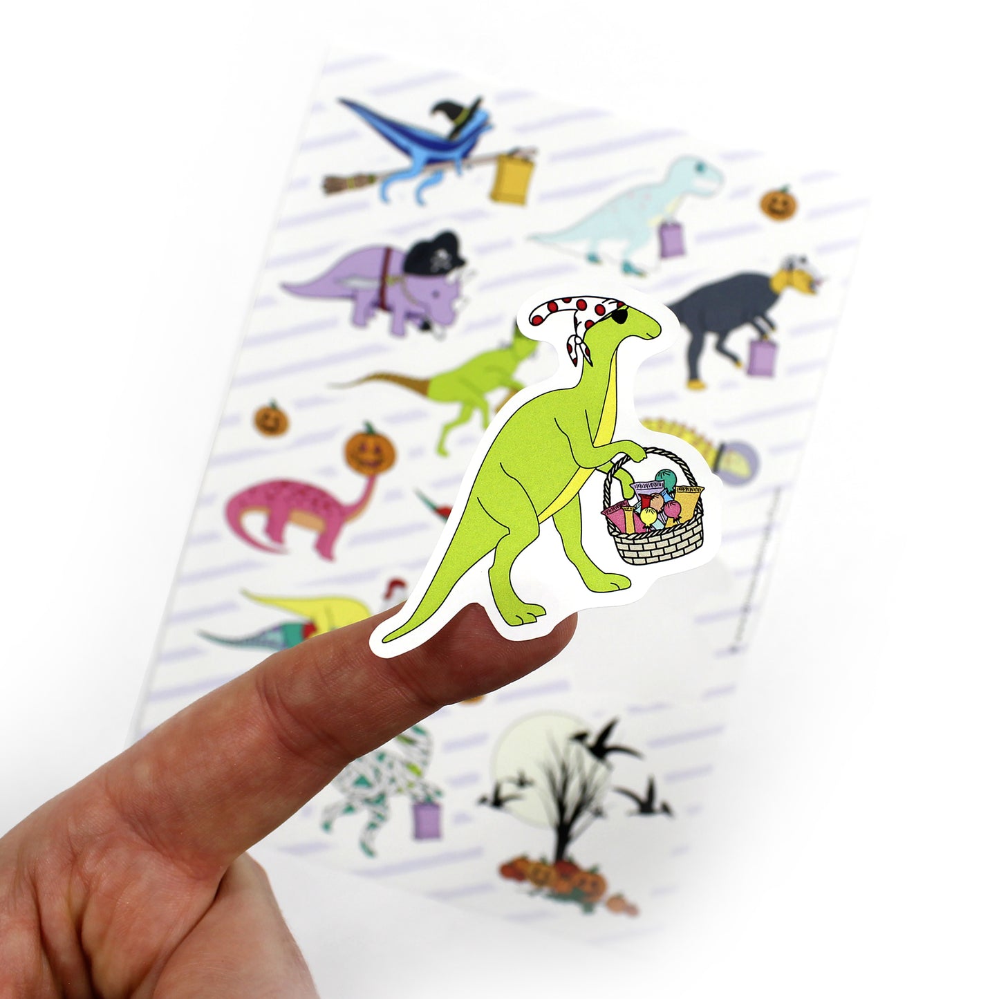 Halloween dinosaur sticker close up with sheet in background
