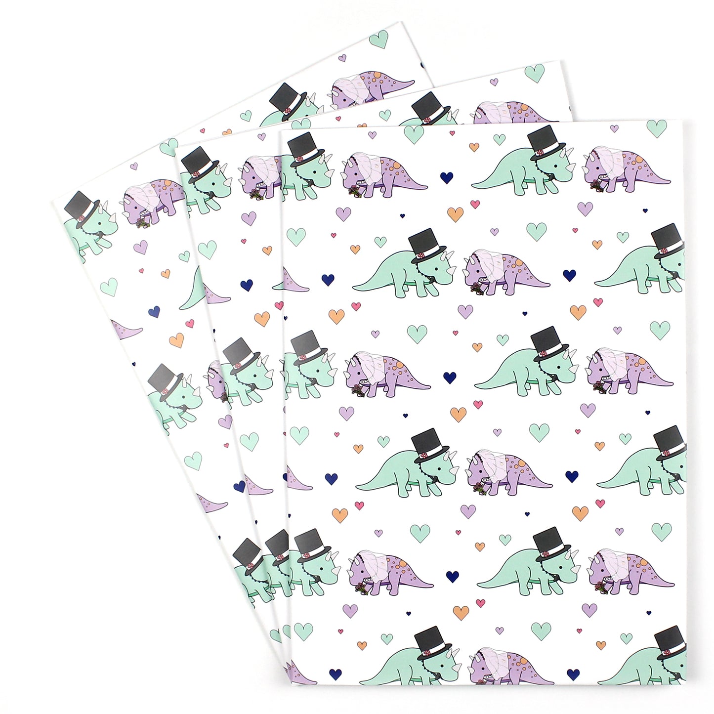 3 sheets of triceratops wedding dinosaur wrapping paper fanned out