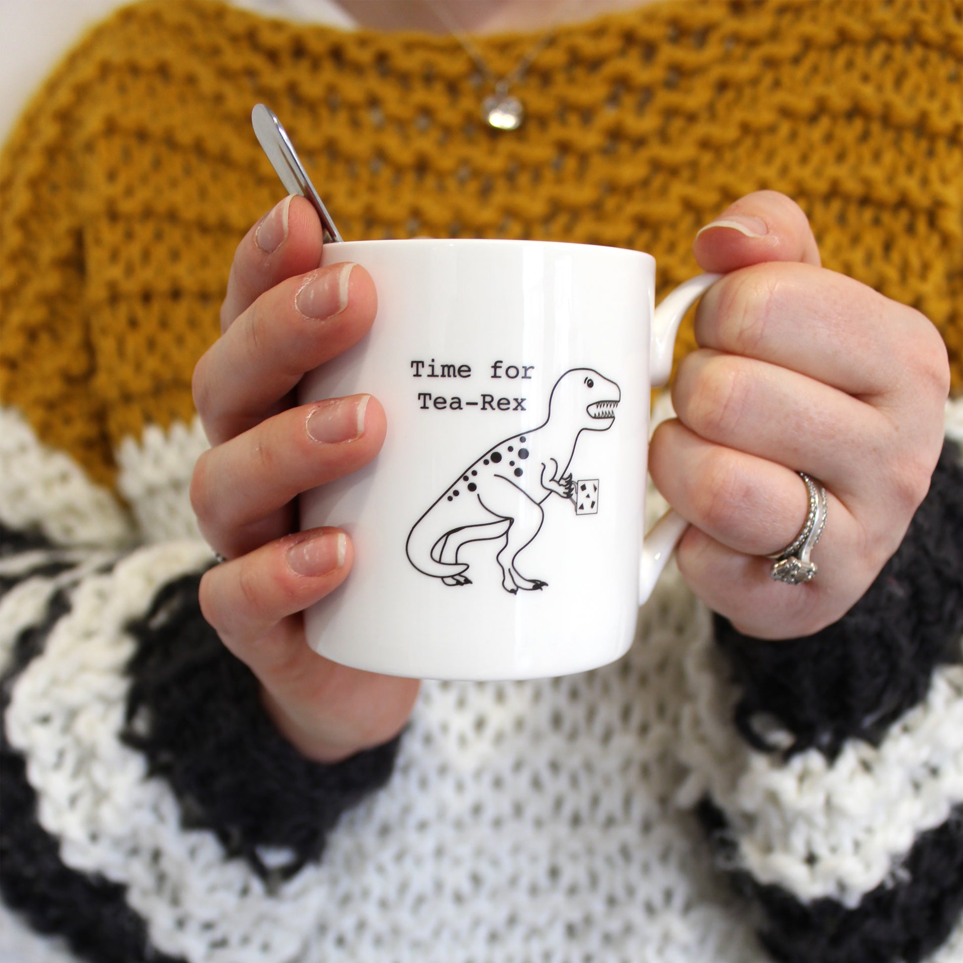 Time for Tea-Rex Mug being held by a person in a mustard, white and grey chunky knit jumper