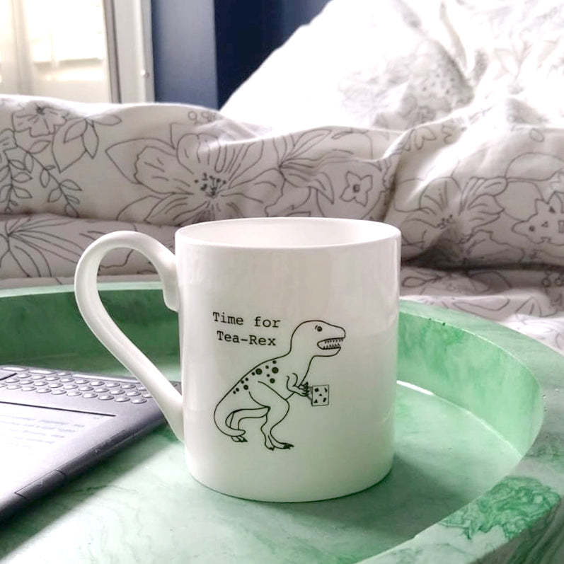 Time for Tea-Rex Mug on a green tray sitting on a floral duvet